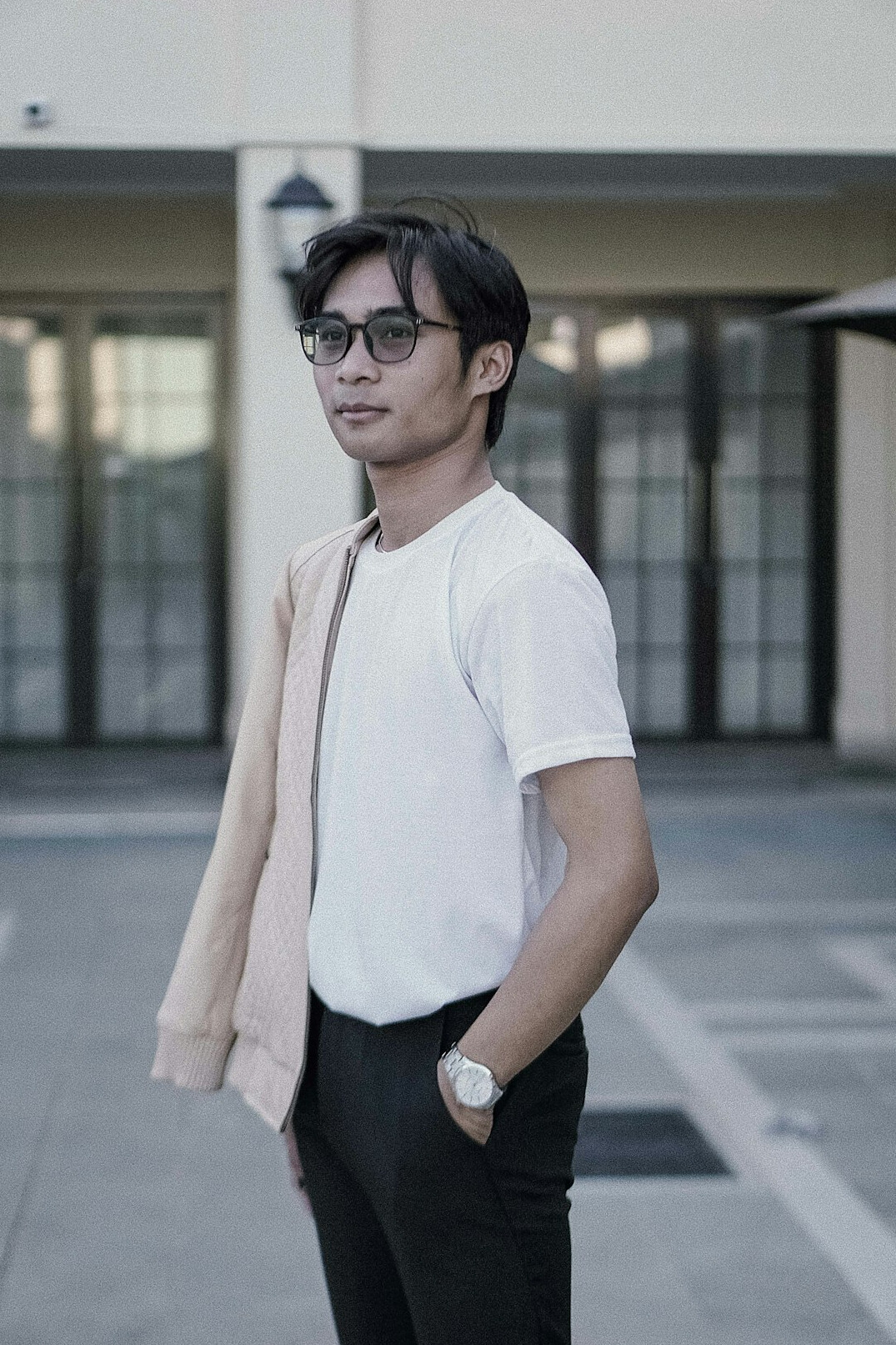 Studio portrait of a young Chinese Singaporean man in casual business wear