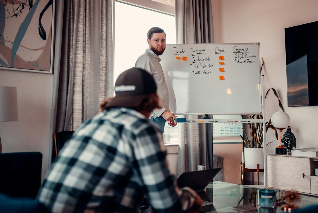 Modern office meeting room with employees discussing around a table